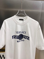 White crewneck short-sleeve T-shirt on hanger with Versace Milano graphic print