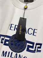 White crewneck T-shirt with large Versace Milano graphic and attached hang tag