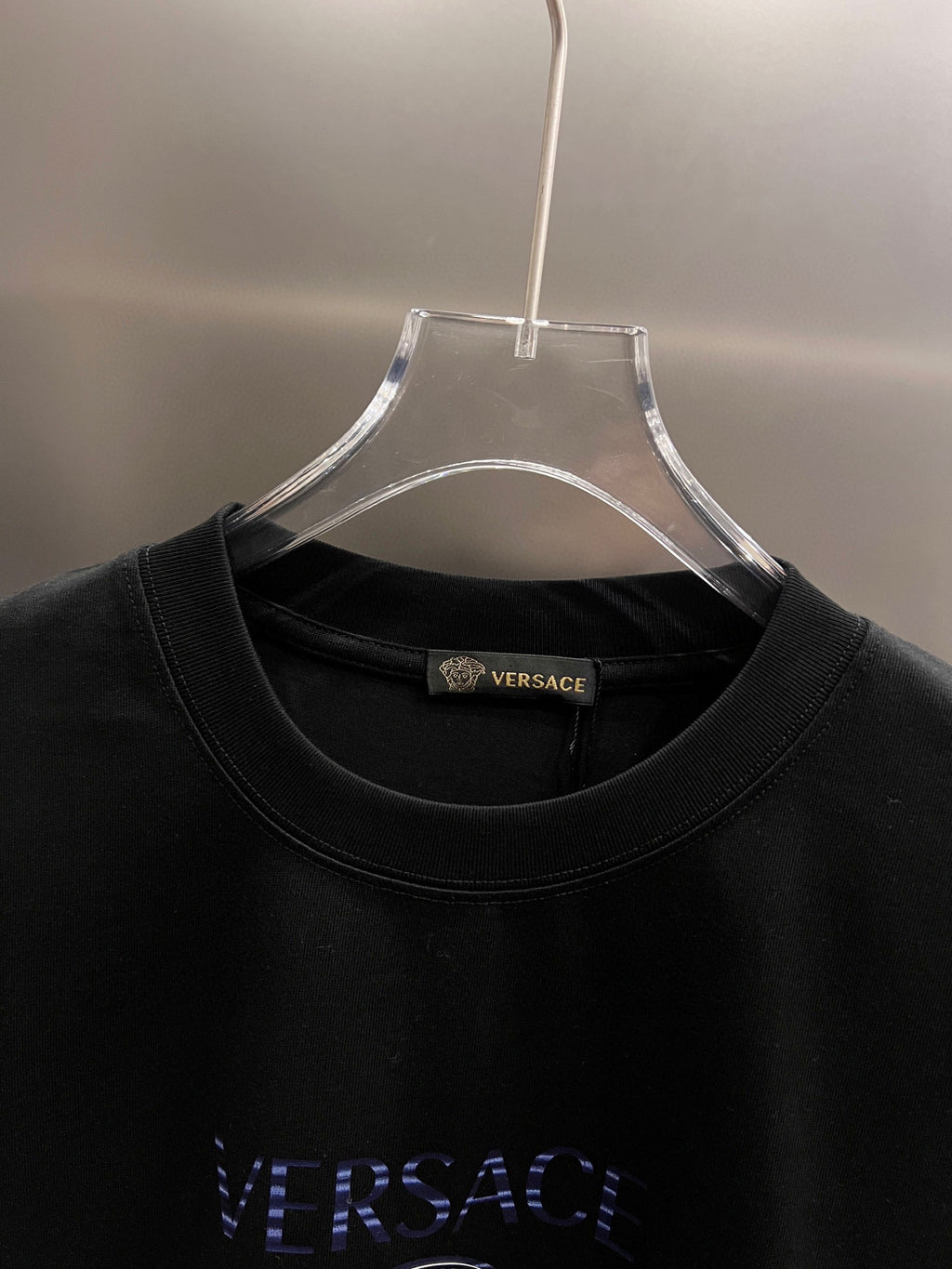 Black T-shirt neckline with Versace tag and stitched collar