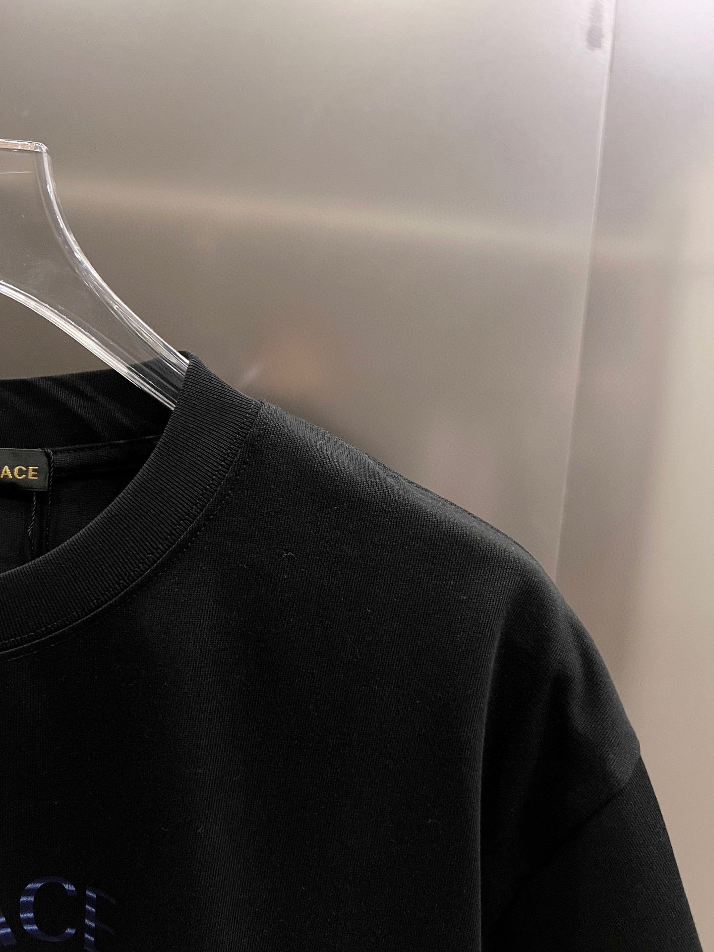 Black T-shirt shoulder and neckline view