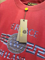 Magenta Versace T-shirt close-up with Medusa logo and neckline tag