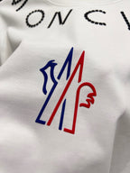 White short-sleeve T-shirt chest logo graphic in blue, red, and white