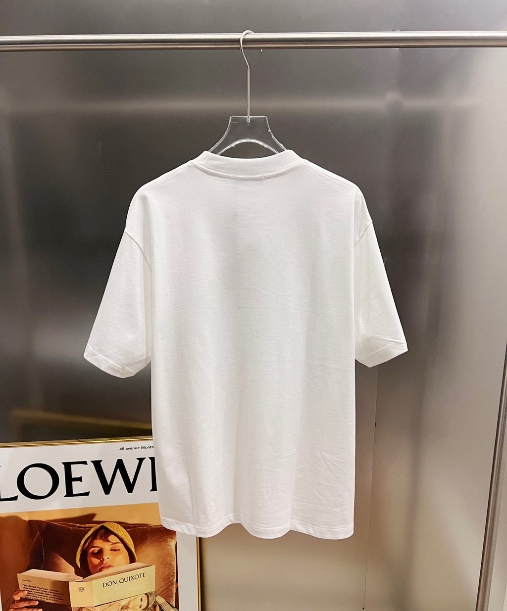 White short-sleeve T-shirt on a hanger, crew neck with plain back