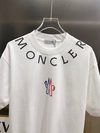 White short-sleeve T-shirt with black dotted "MONCL" lettering and colorful logo