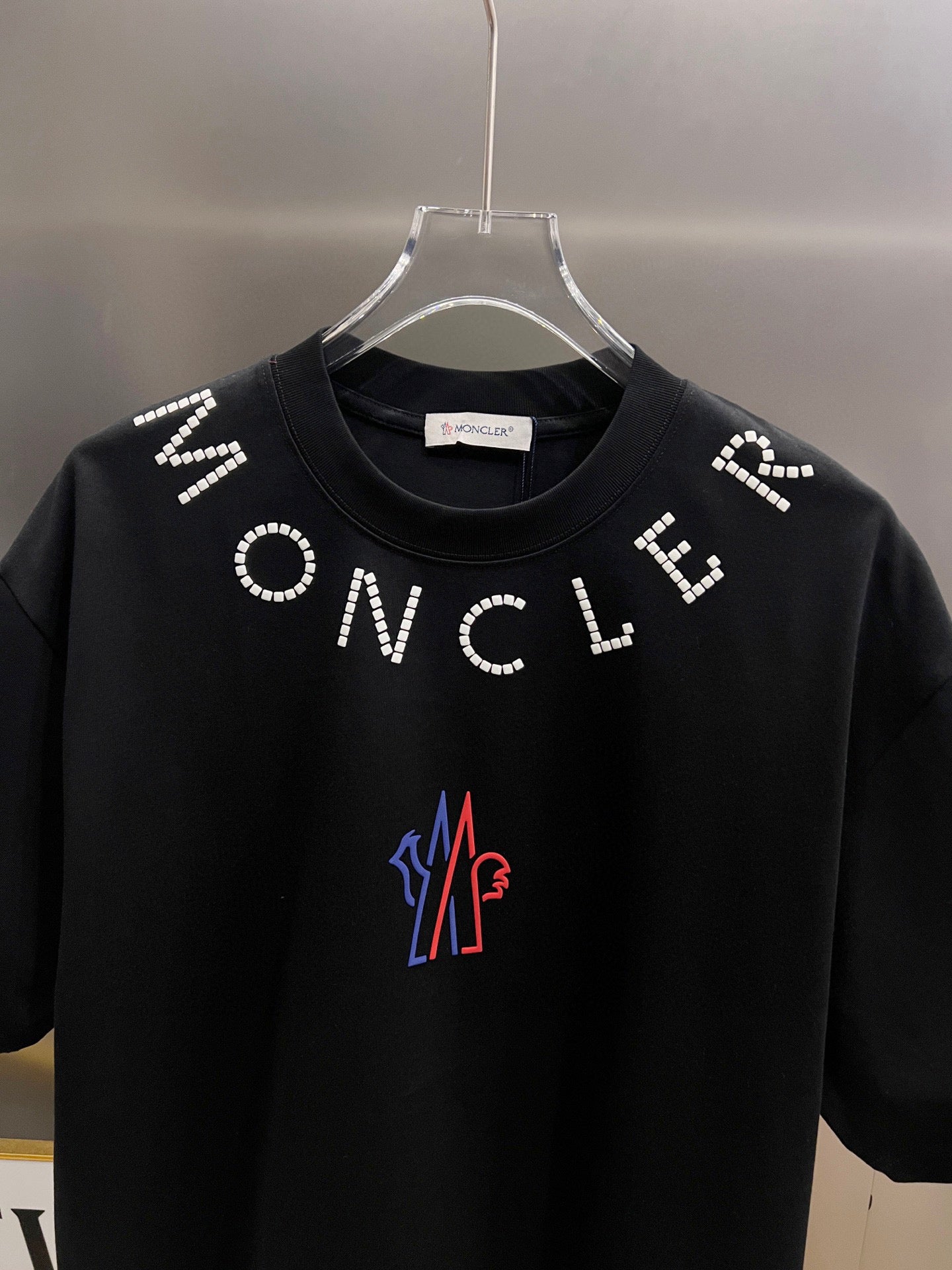 Moncler short-sleeve T-shirt front, black with white ONCLE beaded letters and M logo
