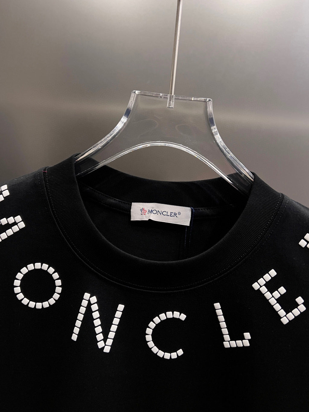 Moncler T-shirt collar, black jersey with white beaded ONCLE lettering