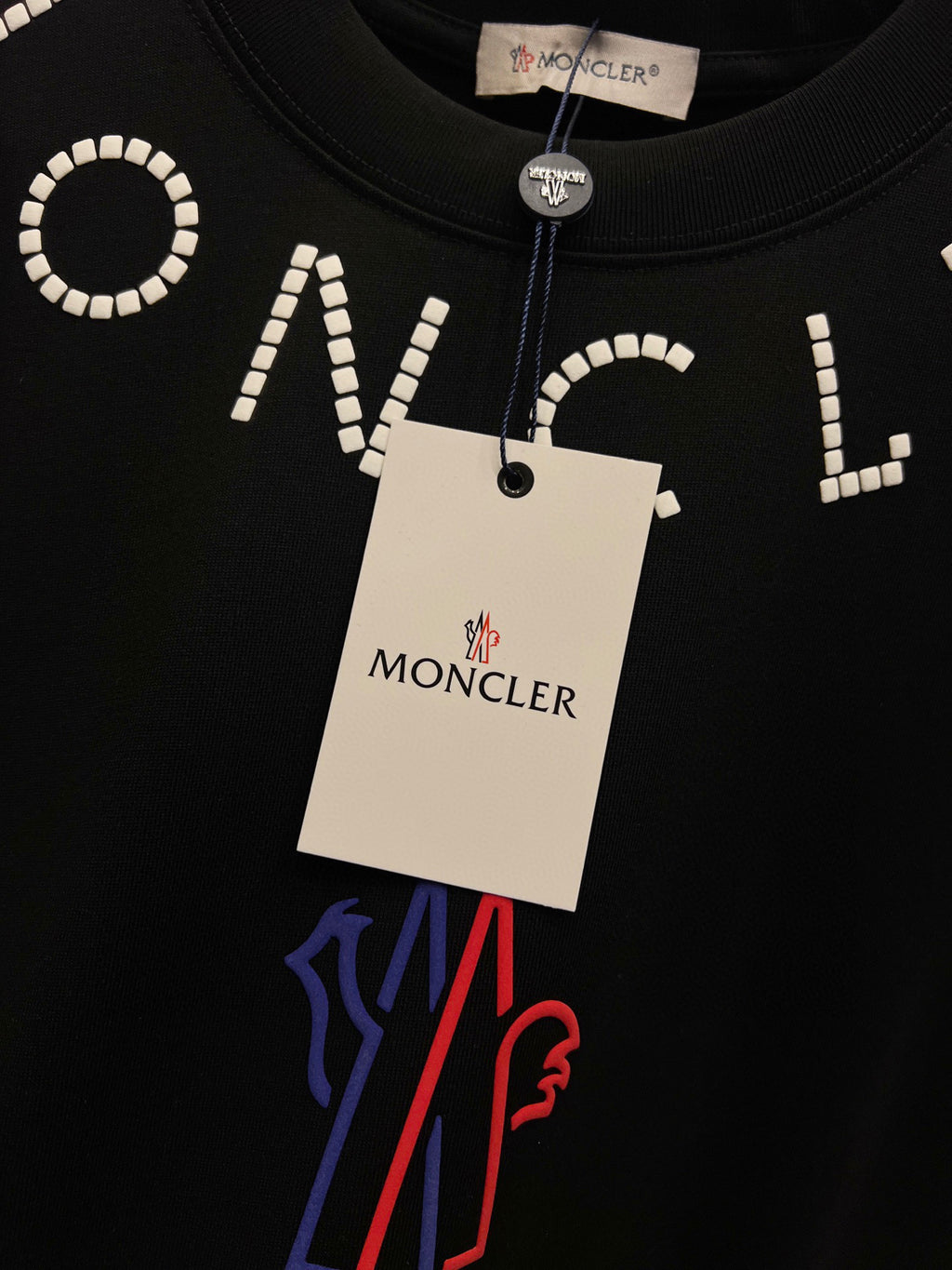 Moncler T-shirt with white beaded word and blue/red M graphic under tag