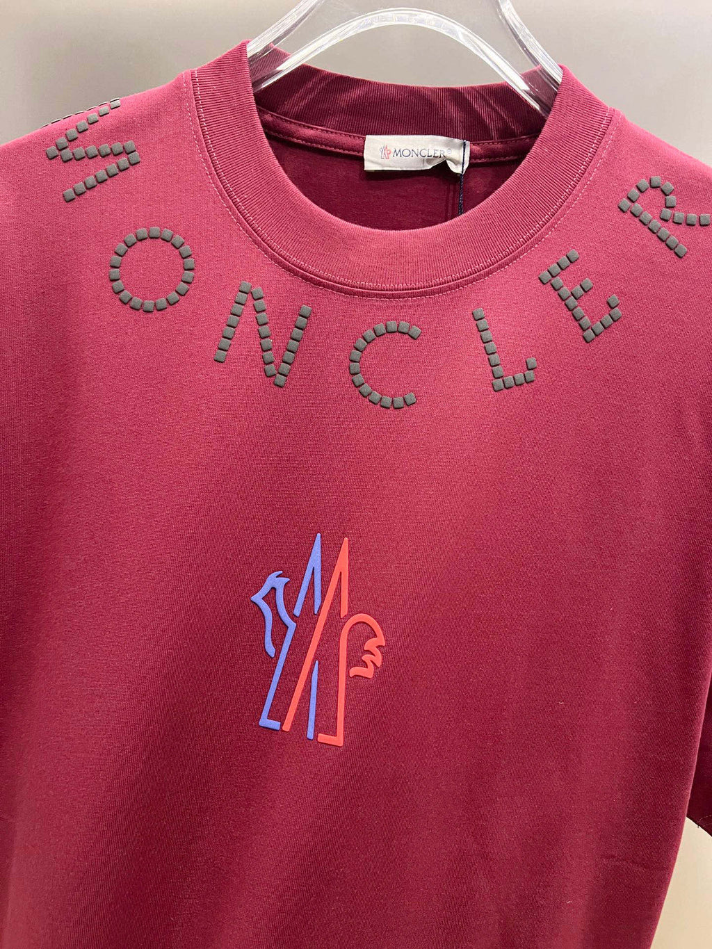 Moncler dark-red short-sleeve T-shirt front close-up with studded lettering