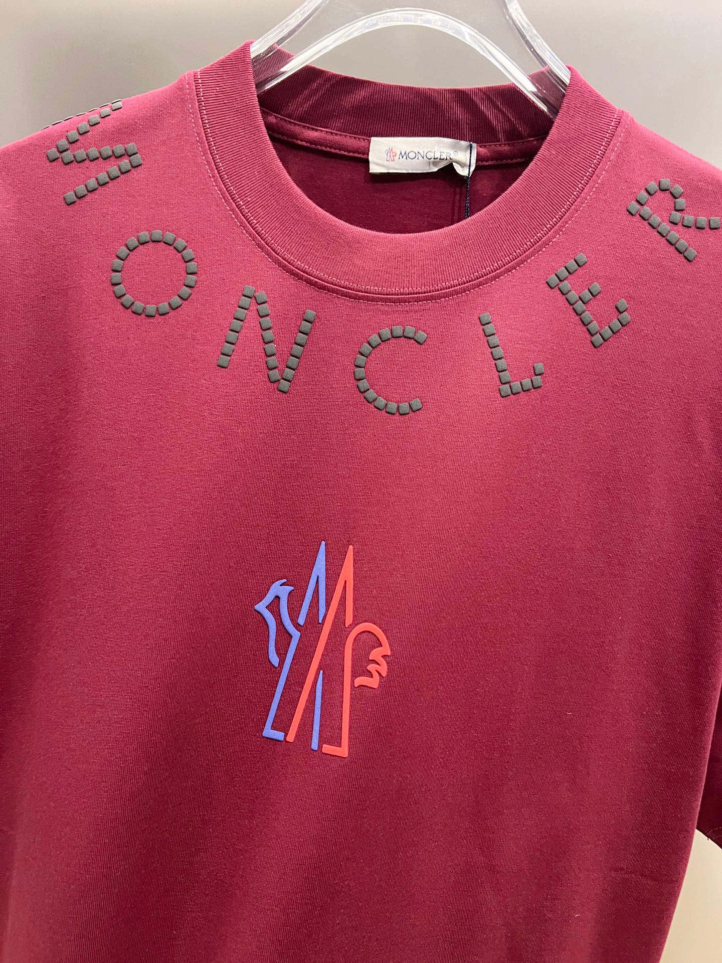 Moncler dark-red short-sleeve T-shirt front close-up with studded lettering