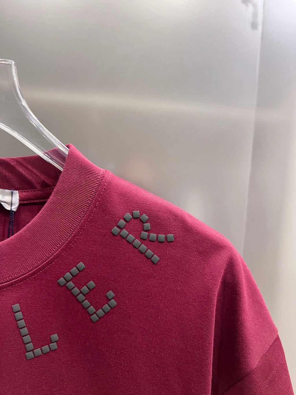 Moncler dark-red short-sleeve T-shirt side close-up with studded detail