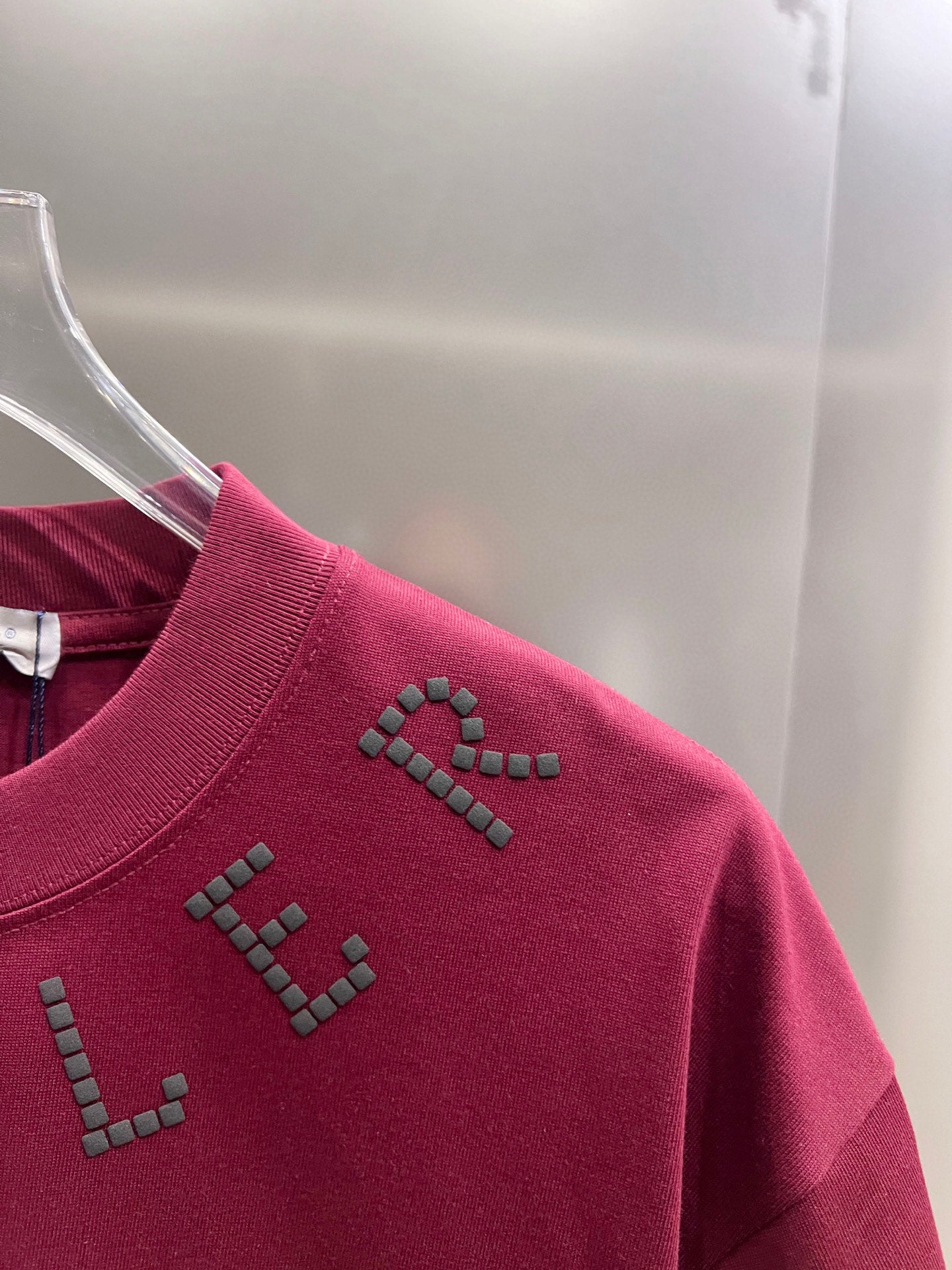 Moncler dark-red short-sleeve T-shirt side close-up with studded detail