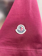 Moncler dark-red T-shirt sleeve close-up with circular logo patch