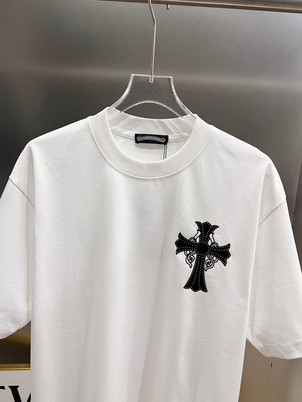 White graphic T-shirt front view with black cross design at the center chest