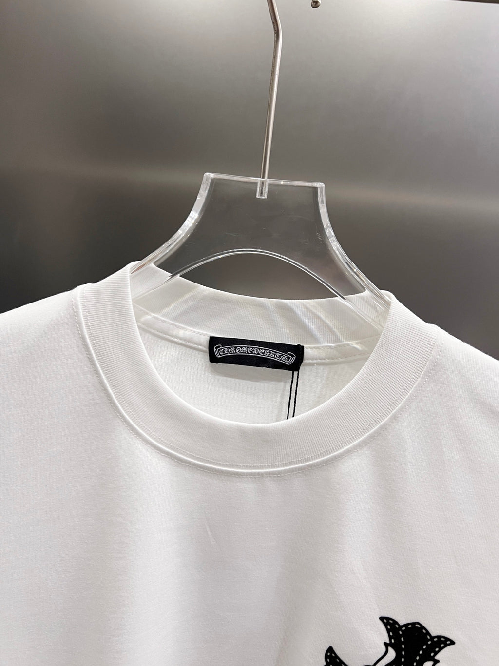 White T-shirt neckline close-up with ribbed collar and inner size label