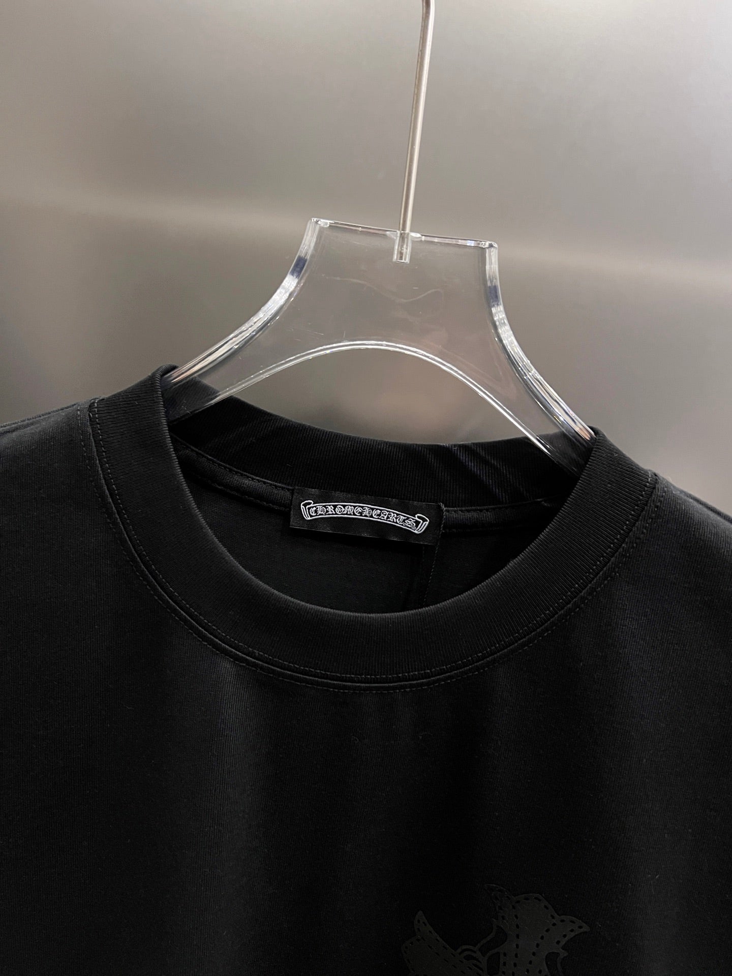 Black crewneck T-shirt with brand label at collar