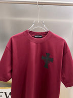 Burgundy short-sleeve T-shirt with small black cross emblem on the front.