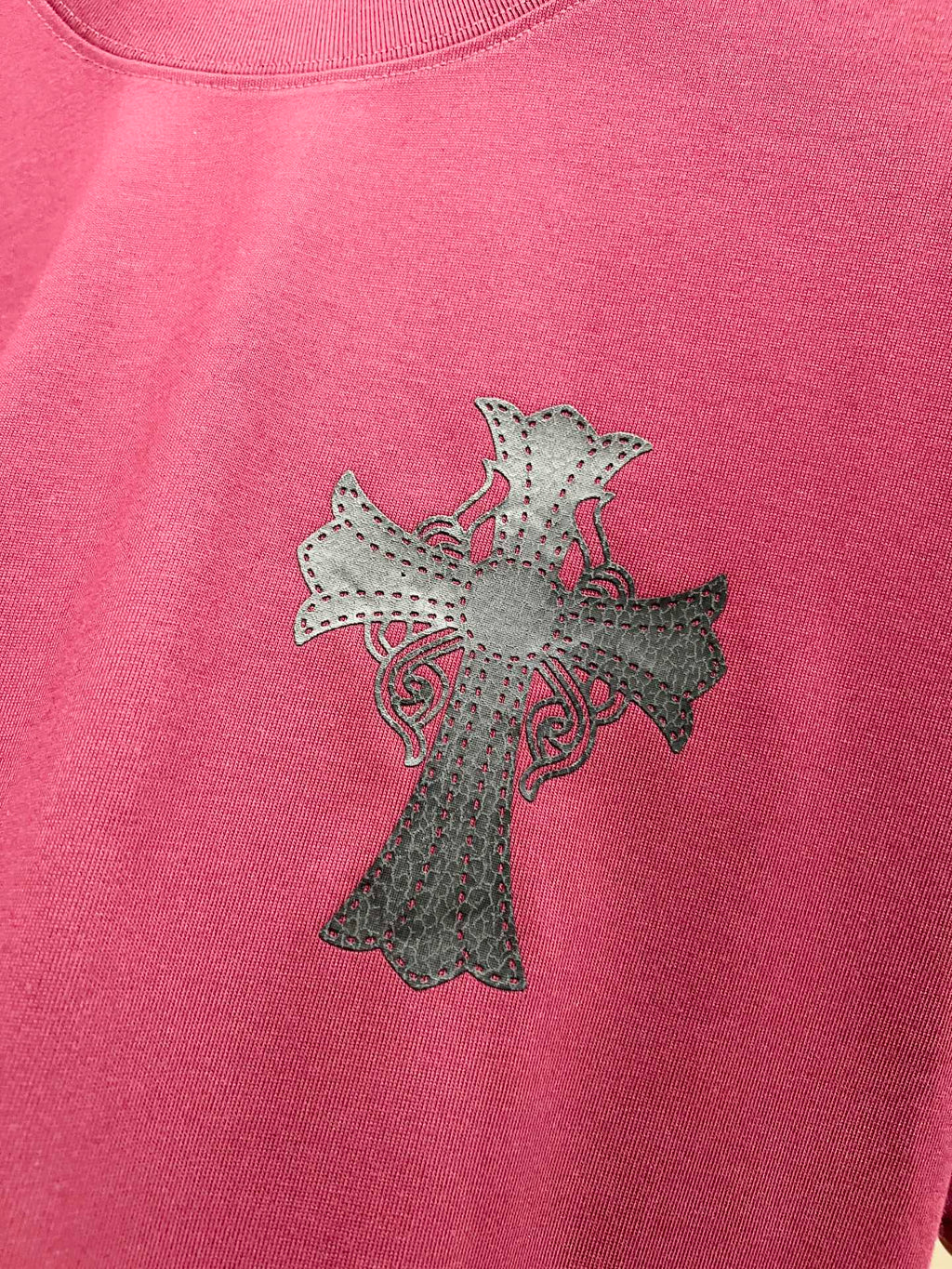 Burgundy T-shirt with light gray cross embroidery with small pink accents.