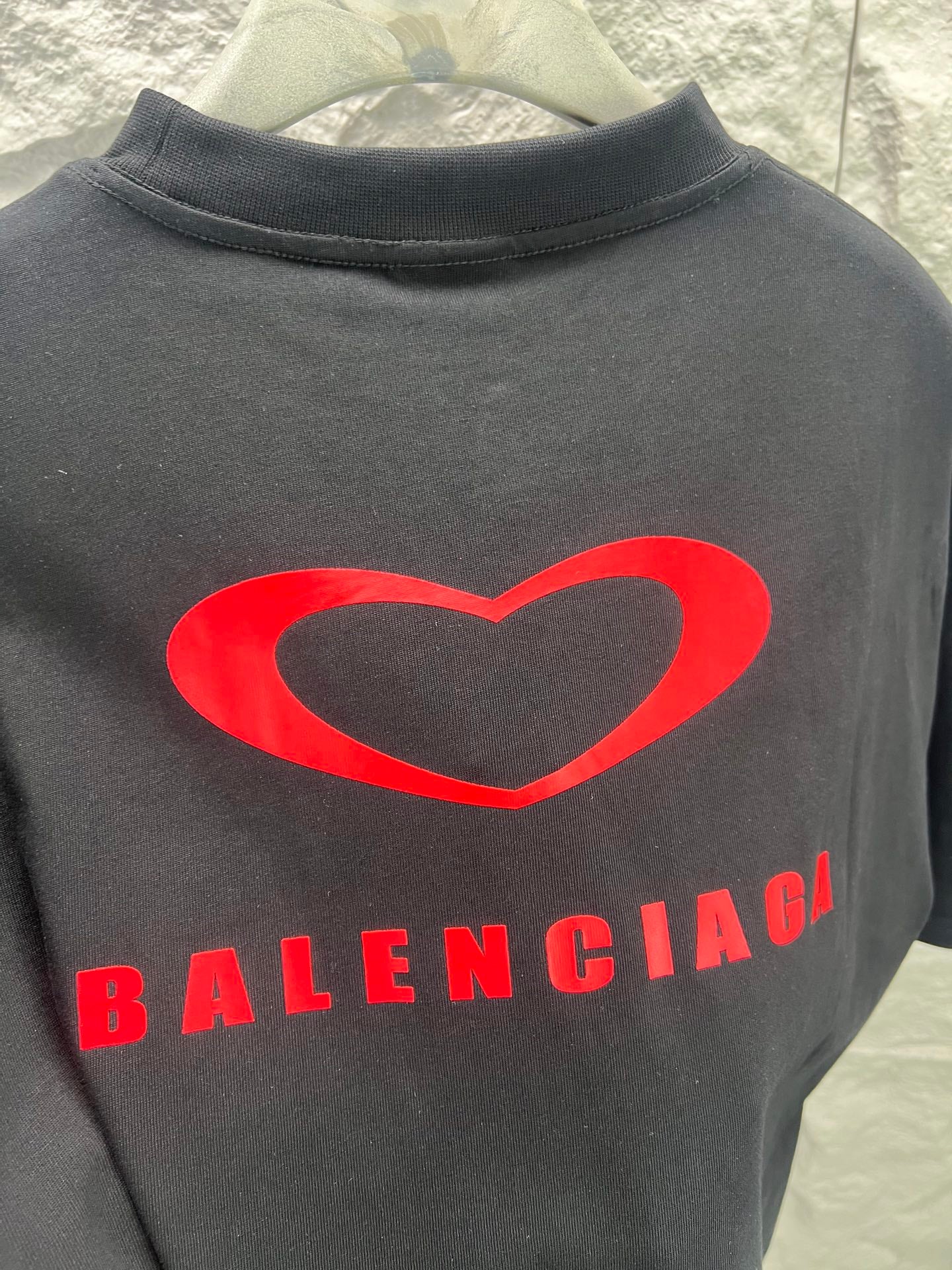 Gray T-shirt close-up of red heart and Balenciaga lettering