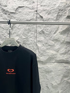 Balenciaga dark T-shirt with small red heart logo on chest