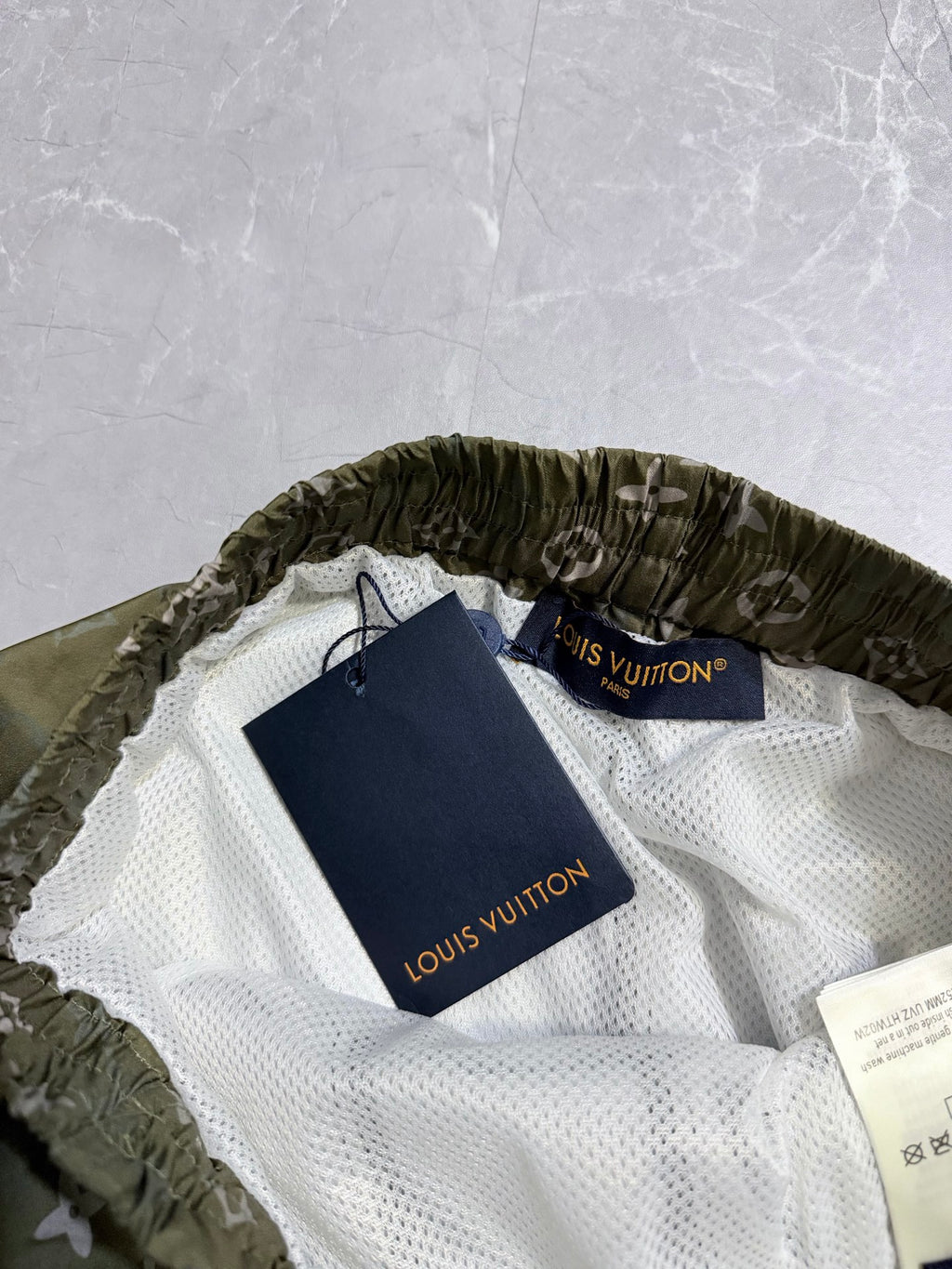 Louis Vuitton monogram shorts on hangers, white mesh lining with drawstring