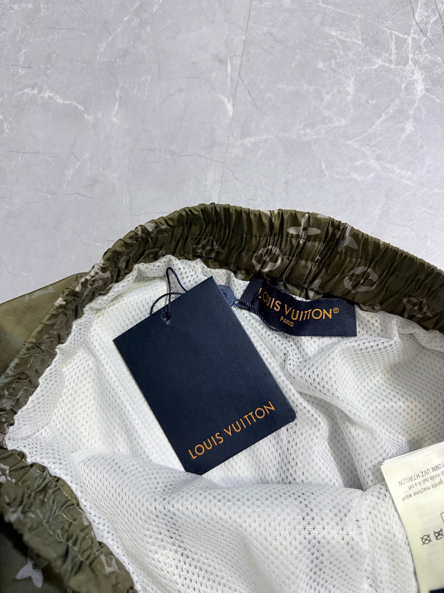 Louis Vuitton monogram shorts on hangers, white mesh lining with drawstring