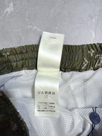 Louis Vuitton shorts care label on white mesh lining with olive elastic waistband