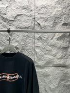 Dark navy Balenciaga short-sleeve T-shirt with partial orange logo detail