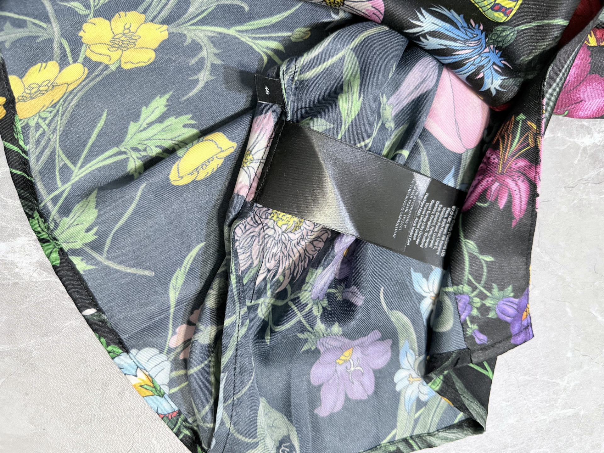 Floral long-sleeve shirt sleeve close-up with black tag and flower print