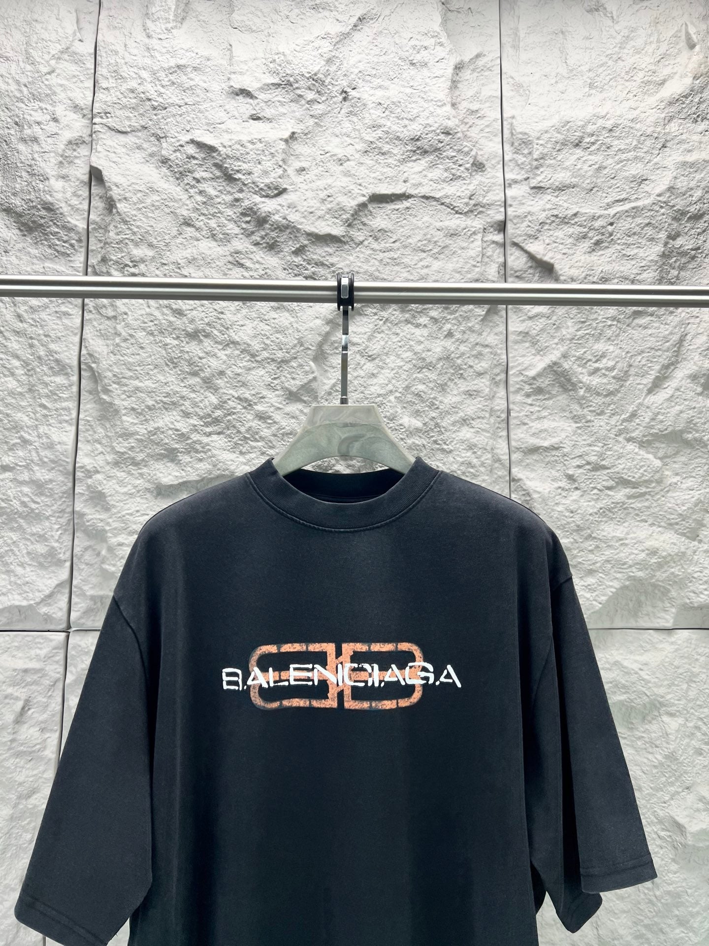 Dark blue Balenciaga short-sleeve T-shirt with orange logo across chest