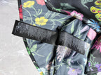 Floral long-sleeve shirt sleeve close-up with stacked black care labels