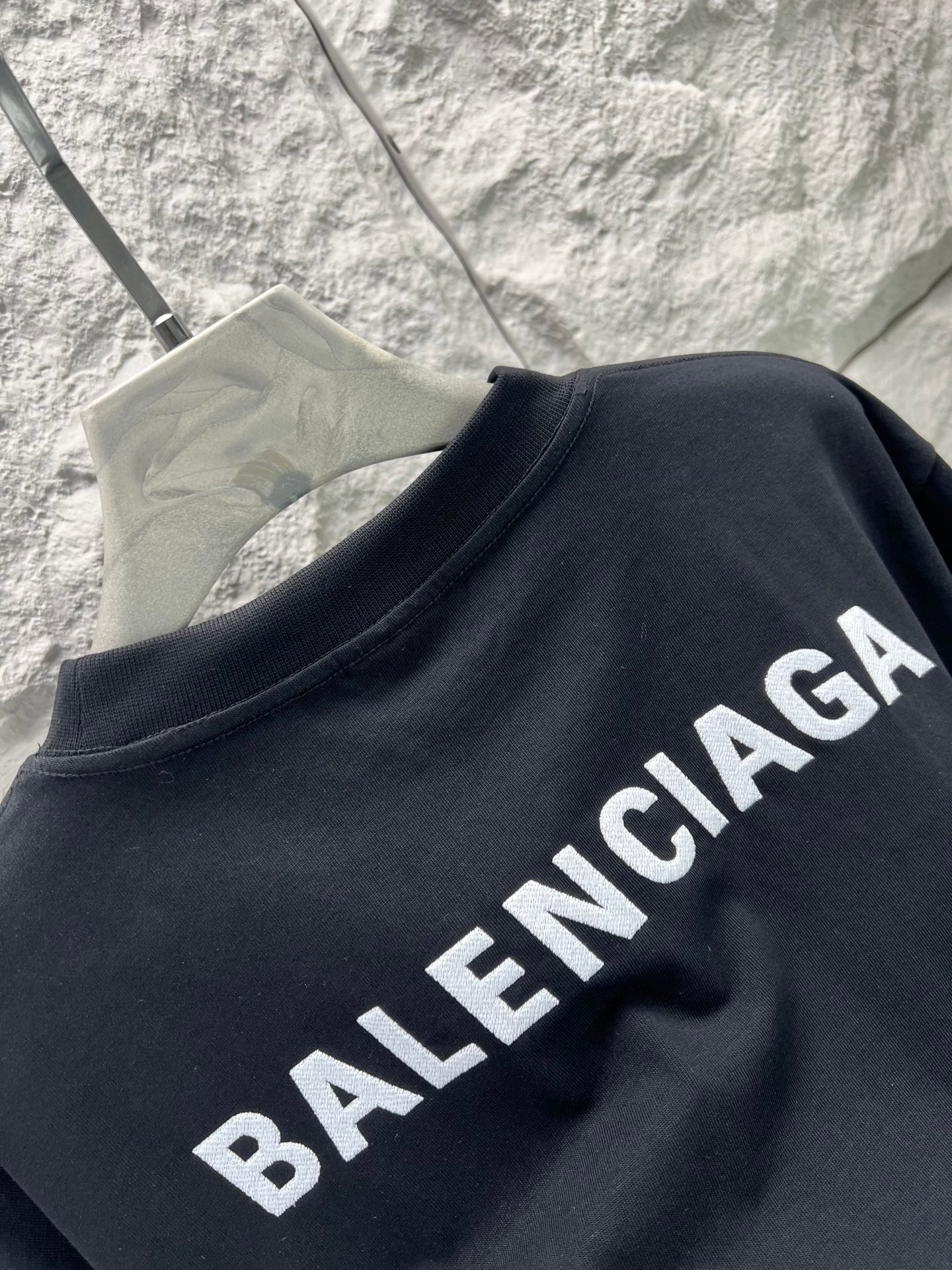 Balenciaga black short-sleeve T-shirt side view, crew neck, slanted BALENCIAGA lettering