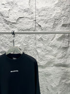 Balenciaga dark T-shirt close-up with BALENCIAGA logo