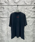 Black short-sleeve shirt with small red Balenciaga logo on chest