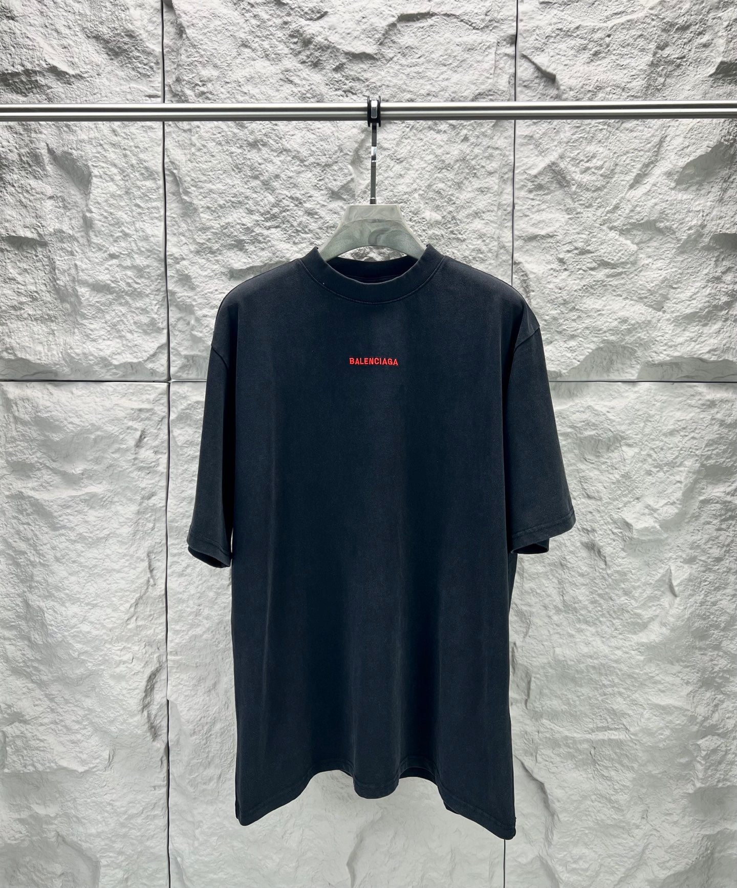 Black short-sleeve shirt with small red Balenciaga logo on chest