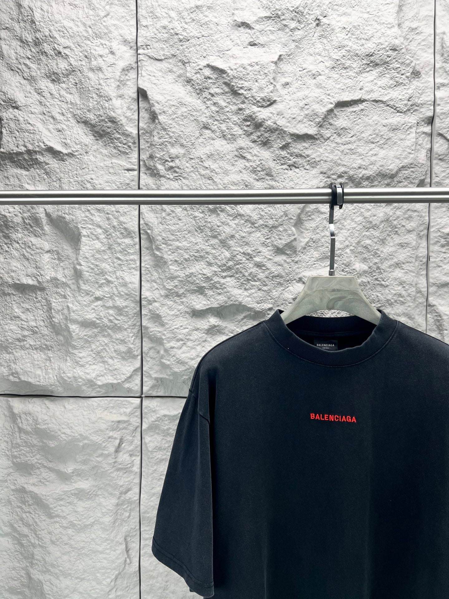 Black short-sleeve shirt with small red Balenciaga logo on chest
