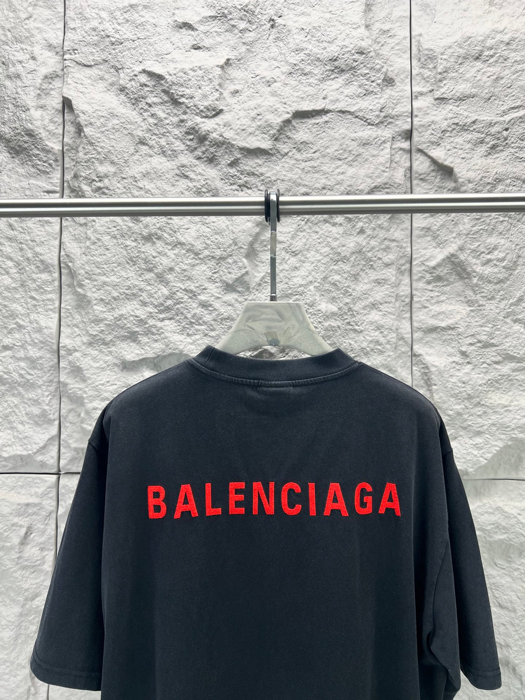 Black short-sleeve shirt with large red Balenciaga logo on back