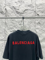 Black short-sleeve shirt with large red Balenciaga logo on back