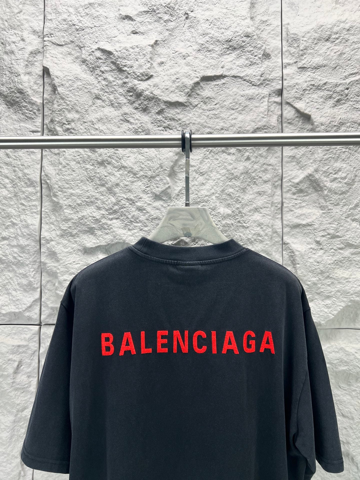 Black short-sleeve shirt with large red Balenciaga logo on back
