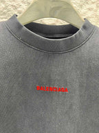 Black short-sleeve shirt close-up of red Balenciaga logo on chest