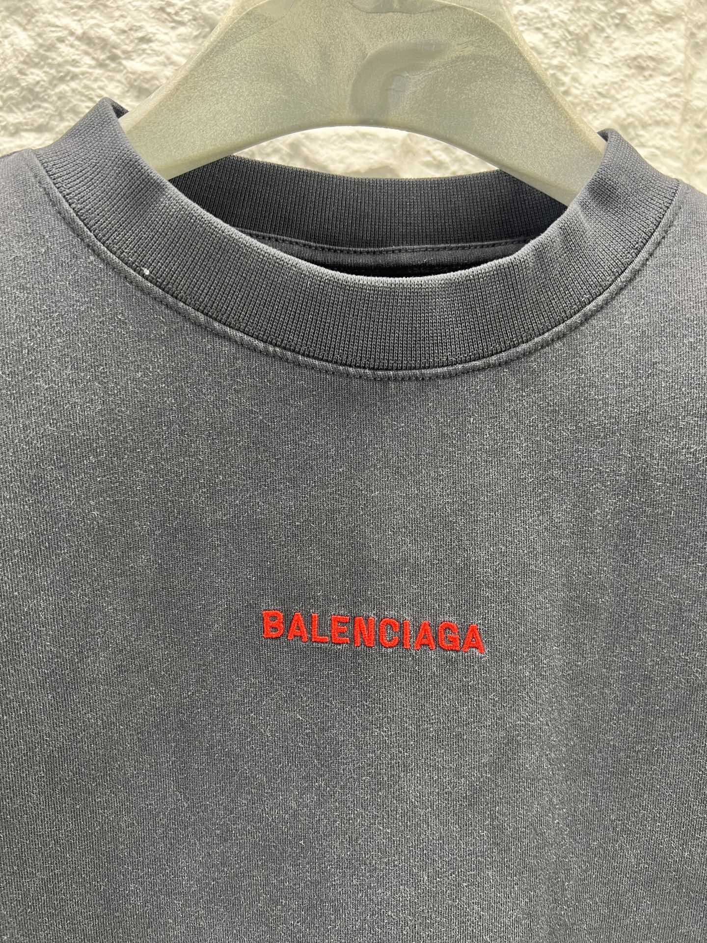 Black short-sleeve shirt close-up of red Balenciaga logo on chest