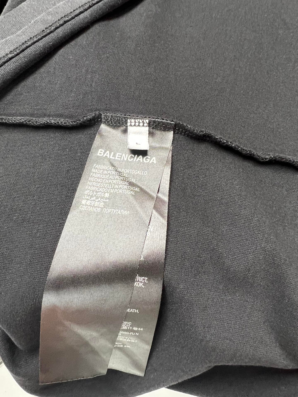 Black short-sleeve shirt fabric tag showing Balenciaga brand label