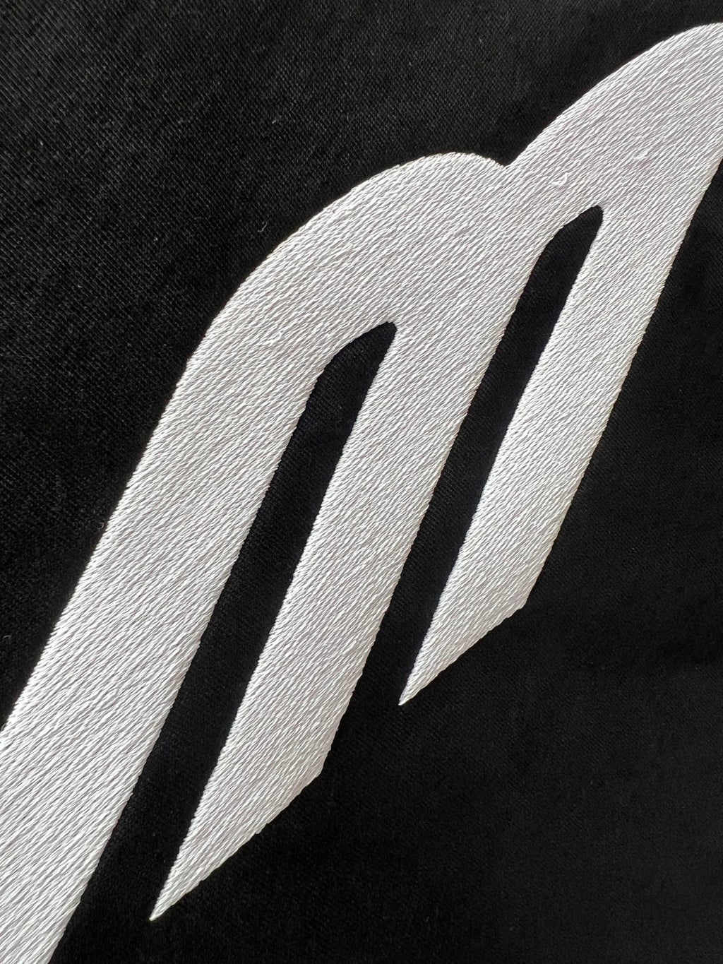Close-up of Balenciaga logo graphic on black fabric