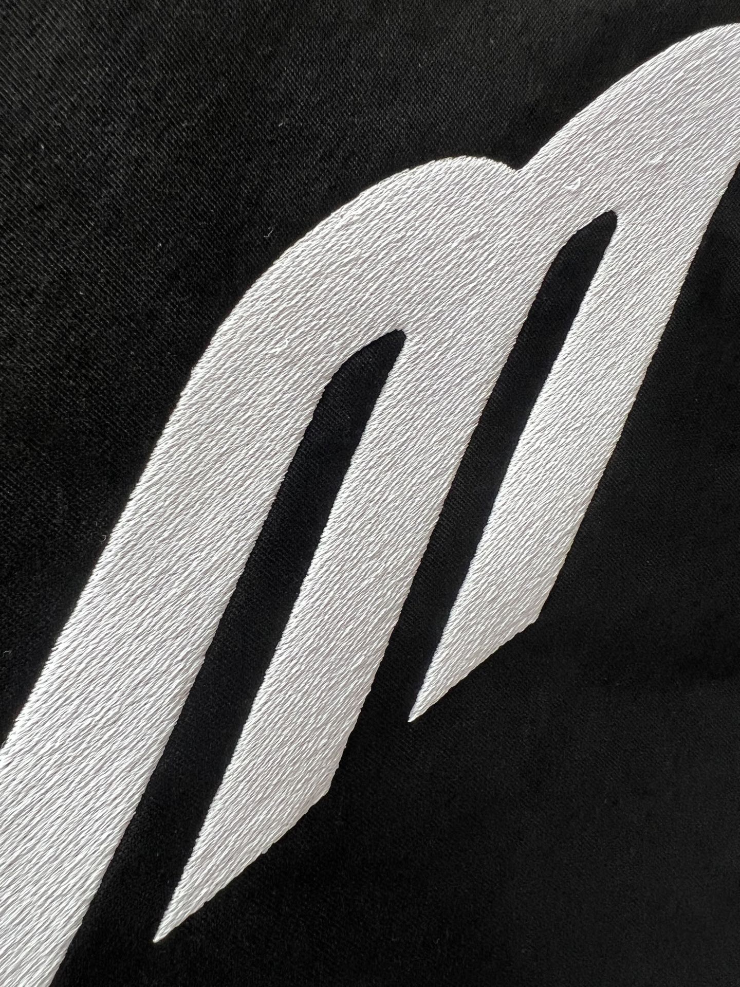 Close-up of Balenciaga logo graphic on black fabric