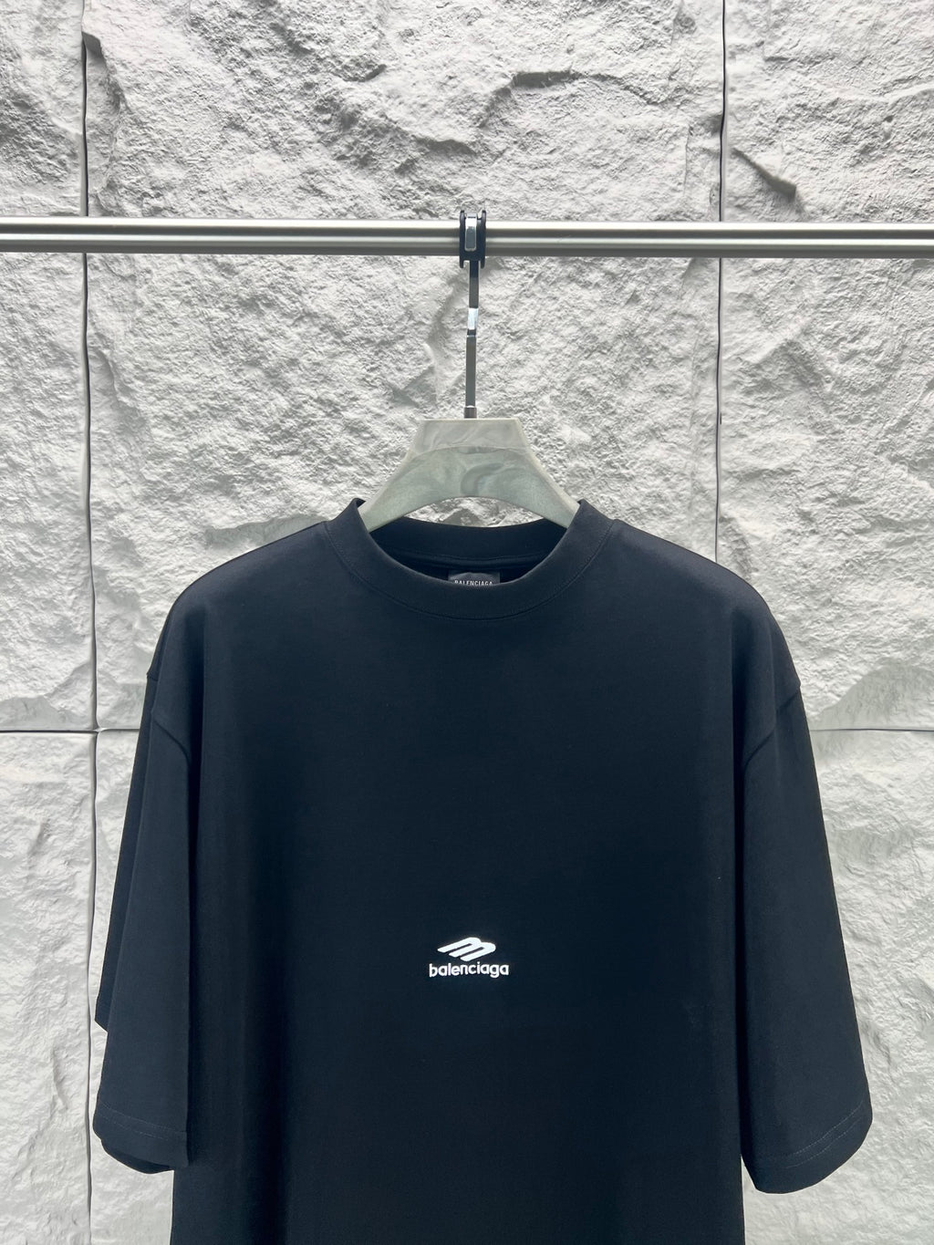 Black Balenciaga crewneck T-shirt on hanger with small chest logo