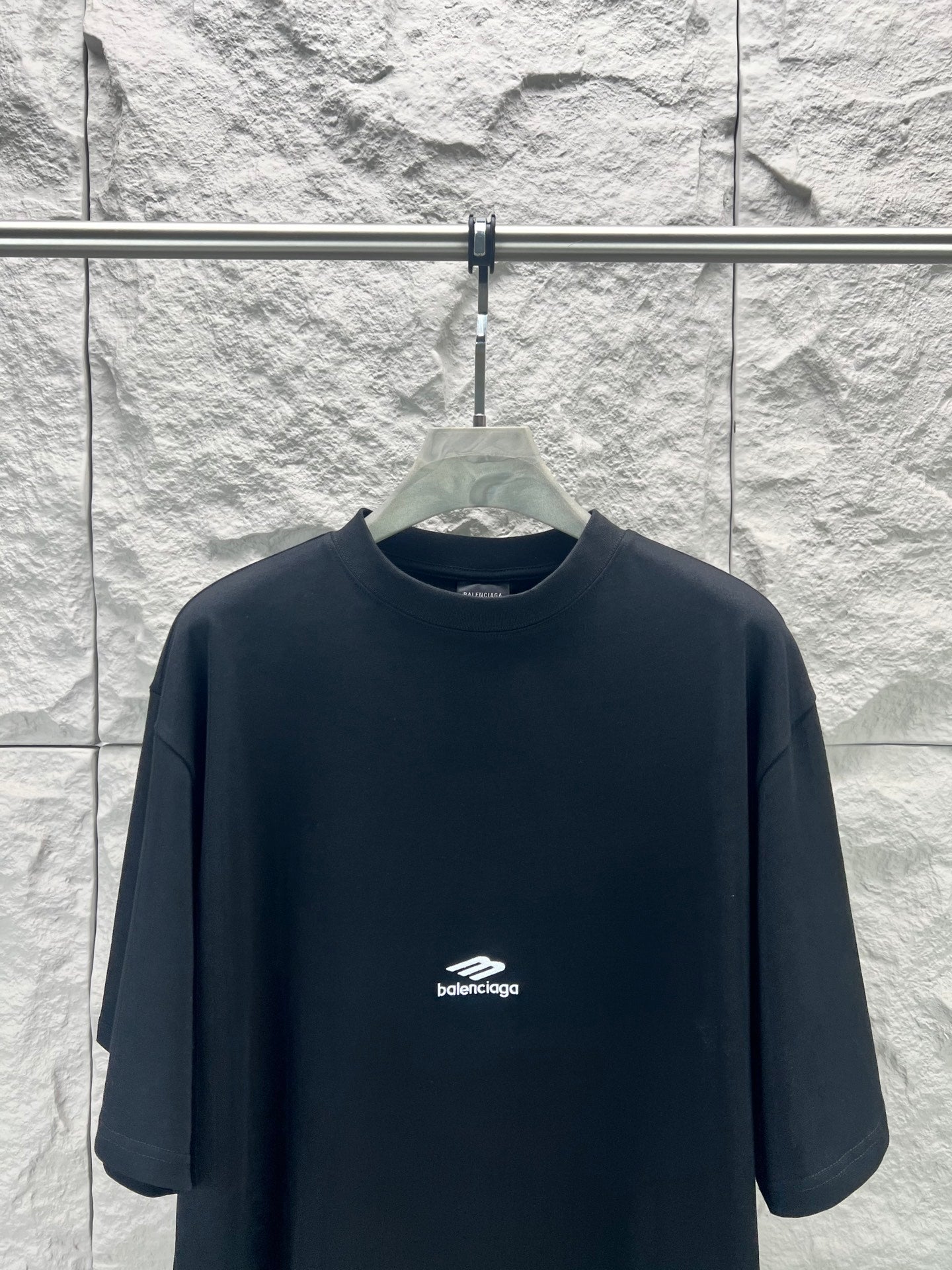 Black Balenciaga crewneck T-shirt on hanger with small chest logo