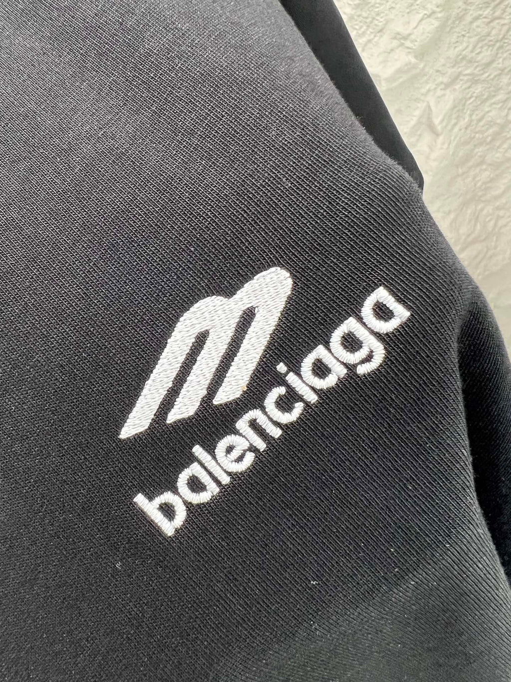 Black fabric close-up with Balenciaga logo lettering