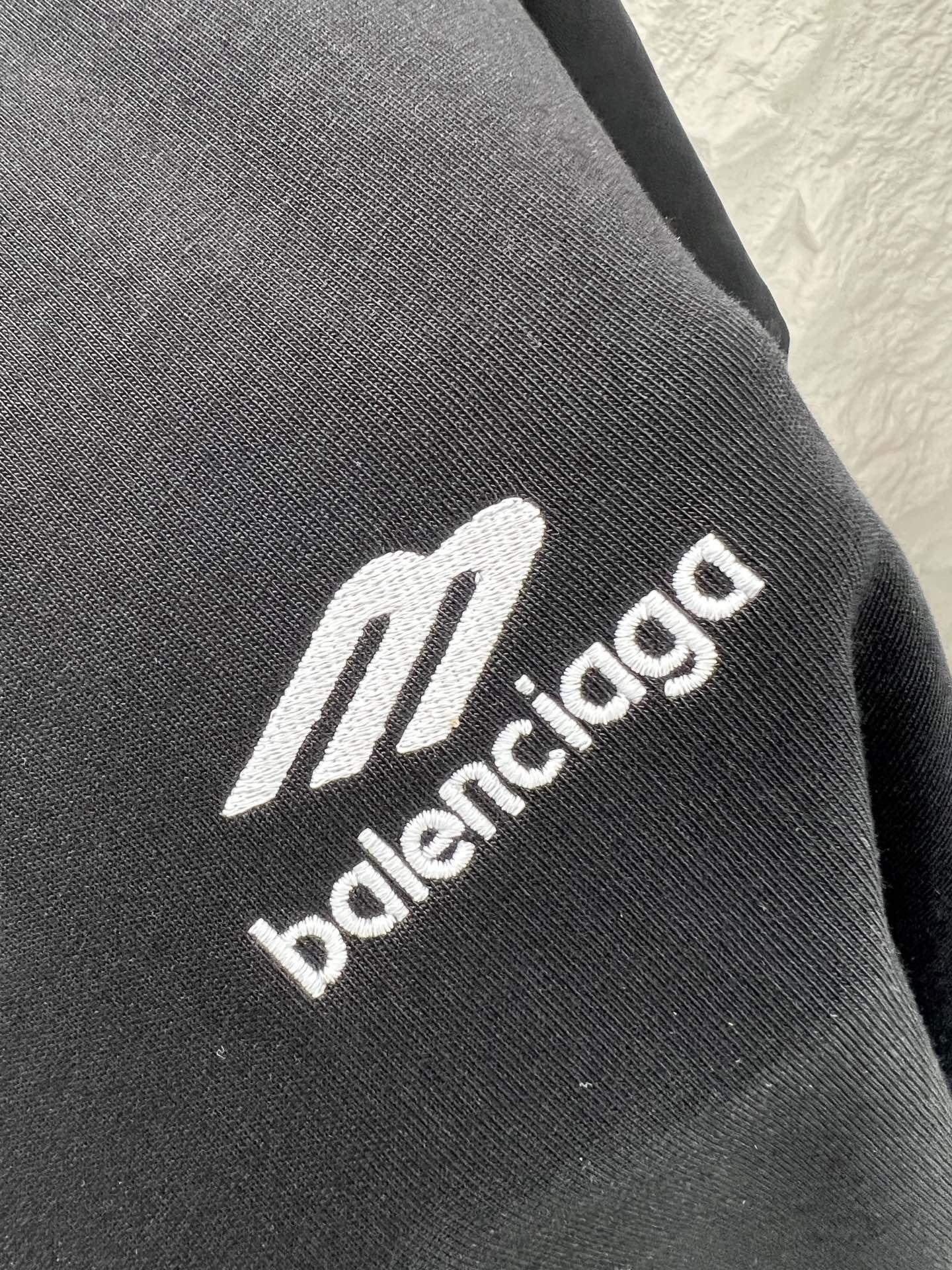Black fabric close-up with Balenciaga logo lettering