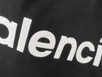 Balenciaga text logo on black T-shirt fabric close-up