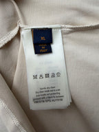 Louis Vuitton T-shirt size XL care label with icons and cleaning instructions.