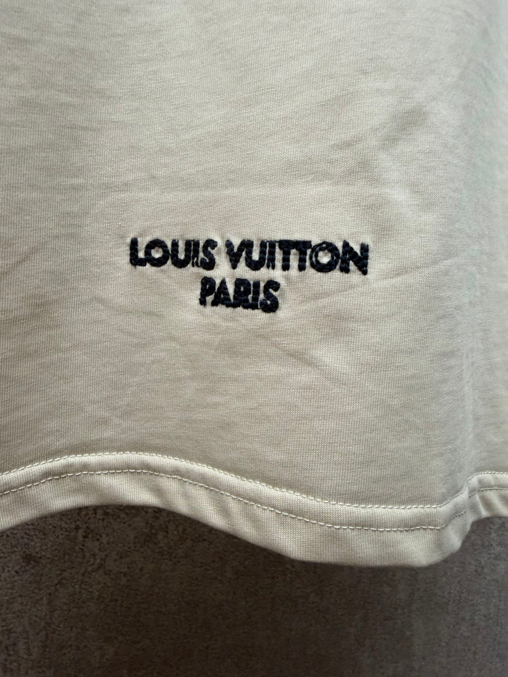 Louis Vuitton T-shirt with 'LOUIS VUITTON PARIS' print near the hem.